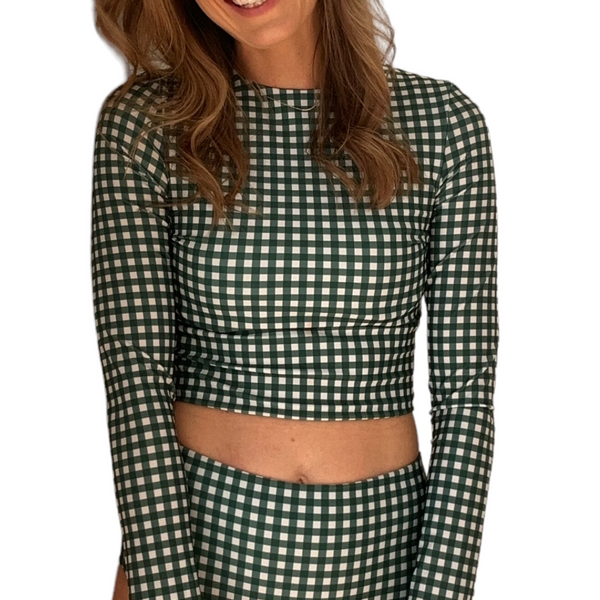 Woman wearing Green Gingham Midi Rash Top with long sleeves and cropped fit, showing checkered pattern detail