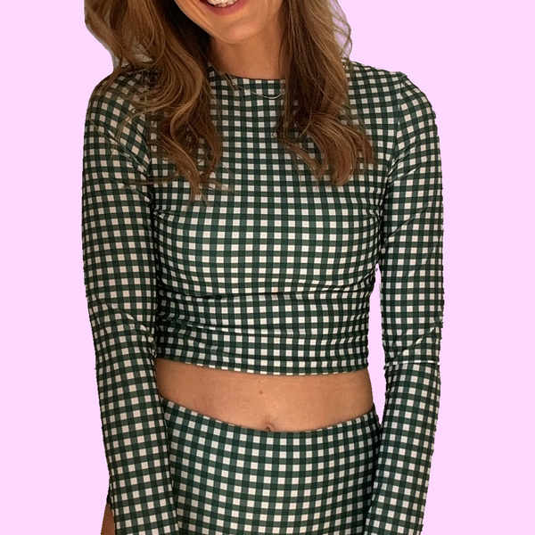 Woman wearing Green Gingham Midi Rash Top with long sleeves and cropped fit, showing checkered pattern detail
