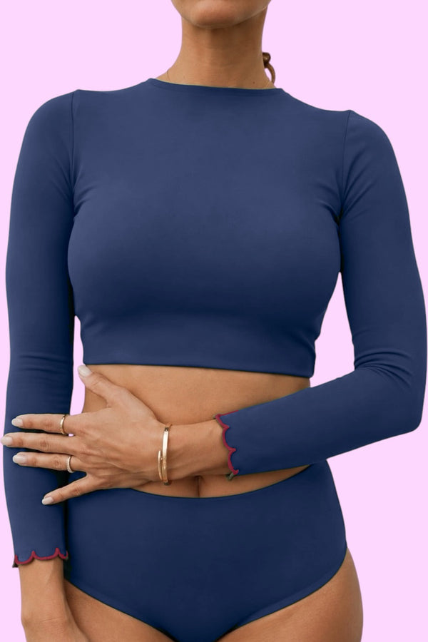 Woman wearing the AVALY navy long sleeve rashie with wine scallop cuffs (digital preview)