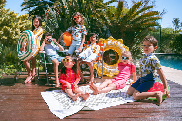 Group of kids wearing colourful Avaly swimwear made from recycled ECONYL materials