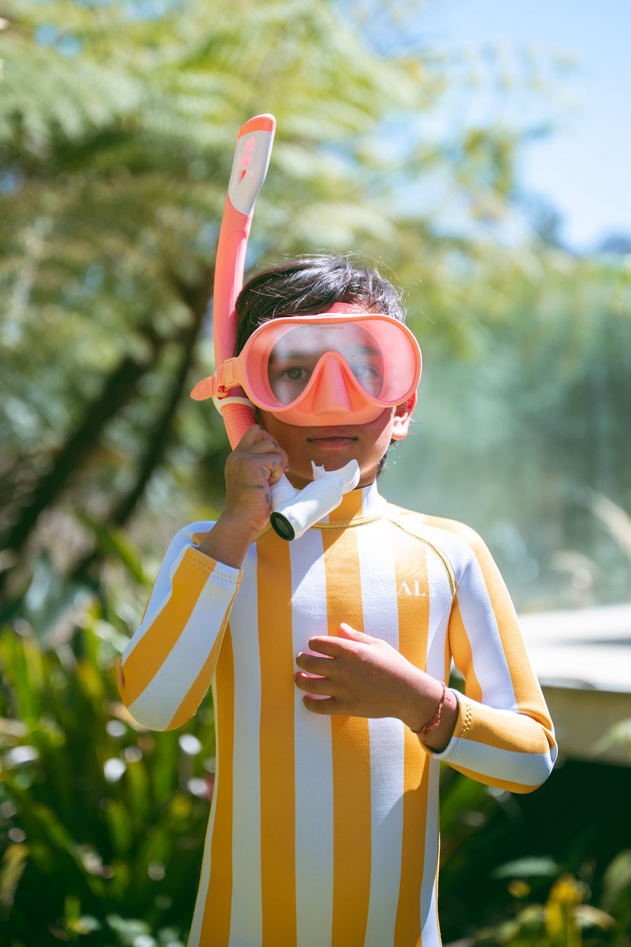 Child in yellow striped AVALY Yulex wetsuit - why we switched from neoprene