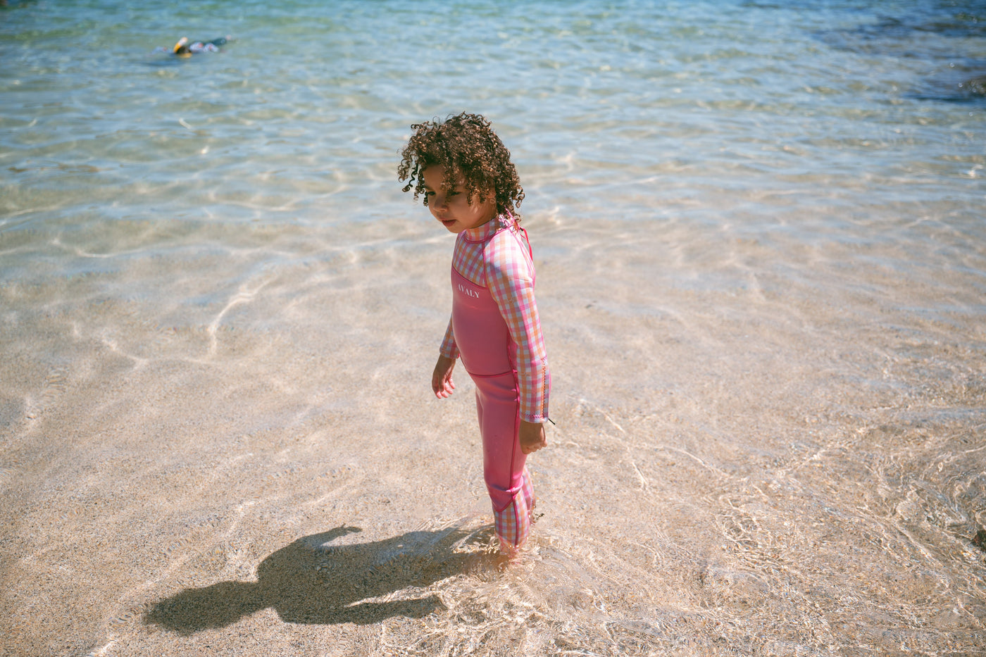Child in AVALY steamer standing in cool Australian water
