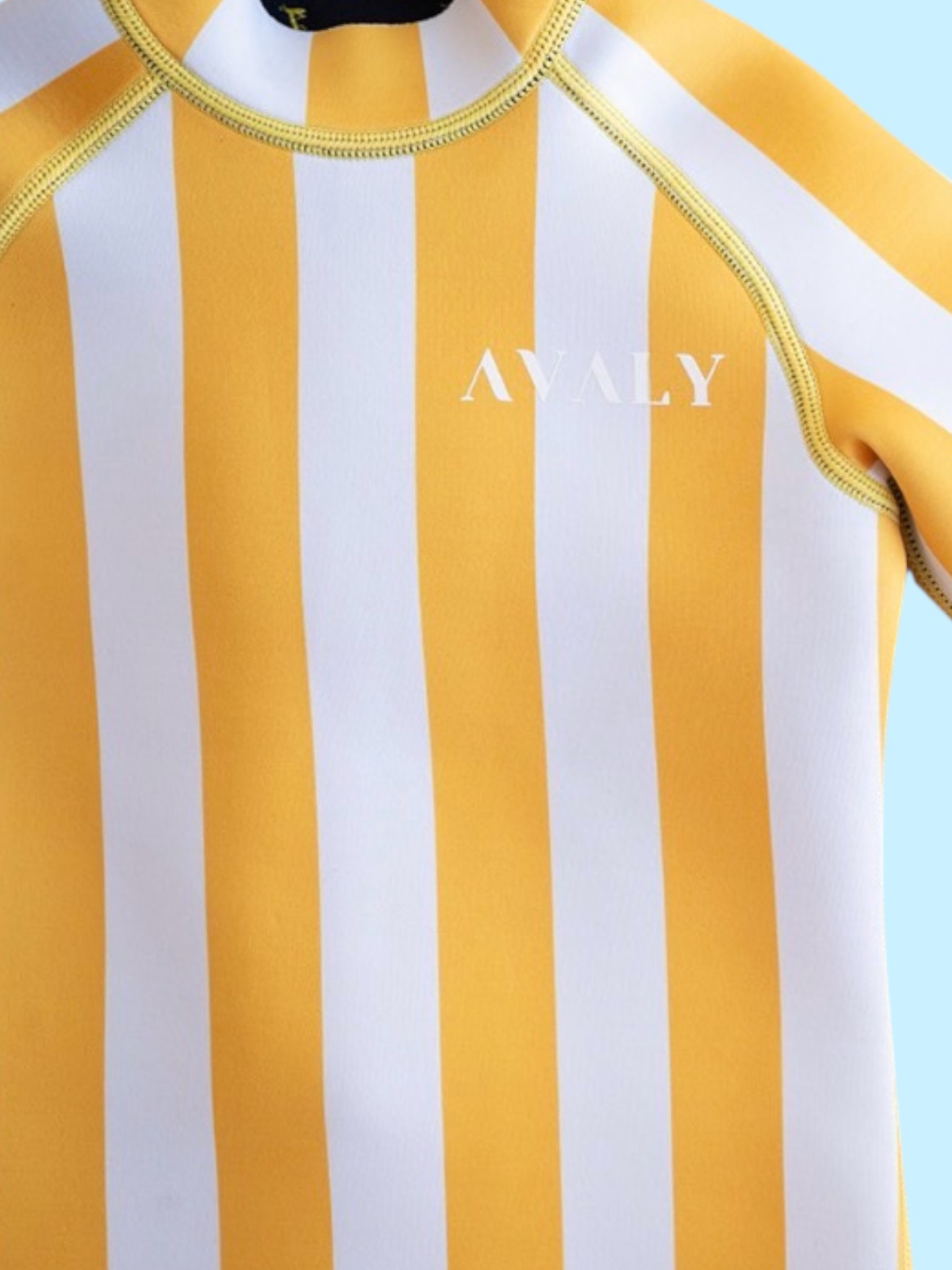 Close up detail of Yellow Stripe Kids Wetsuit showing vertical orange and white striped pattern with Avaly branding