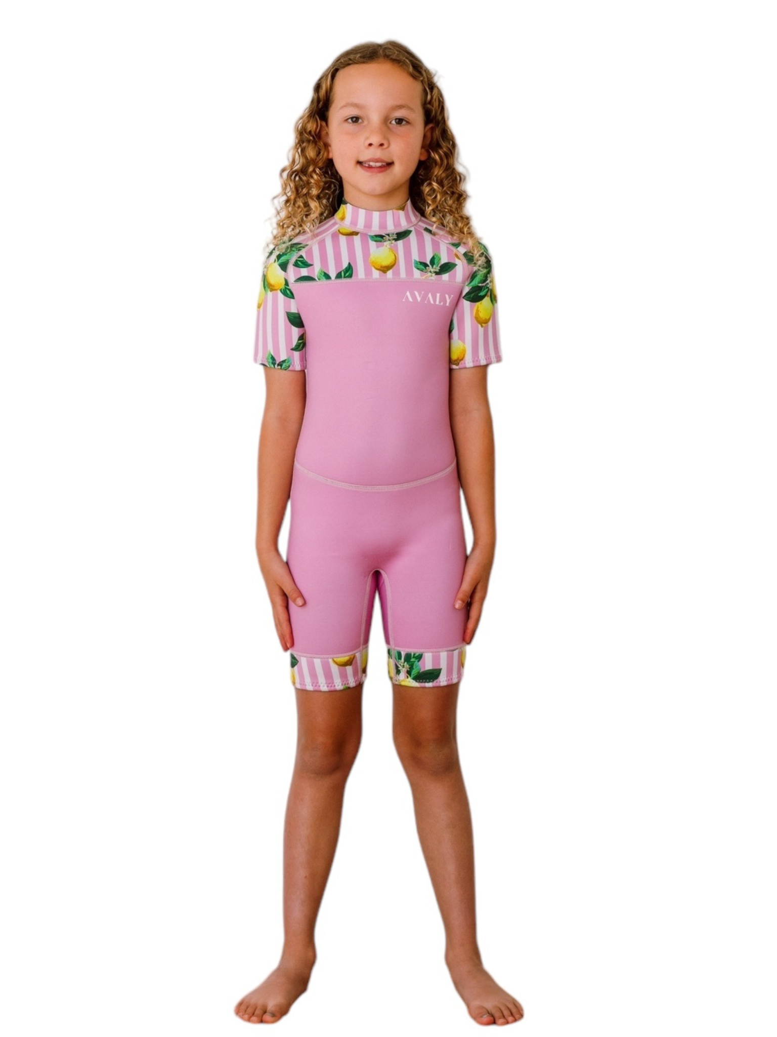 Girl wearing Pink Lemon Stripe Kids Wetsuit with pink and white striped sleeves, yellow lemon print, and pink body