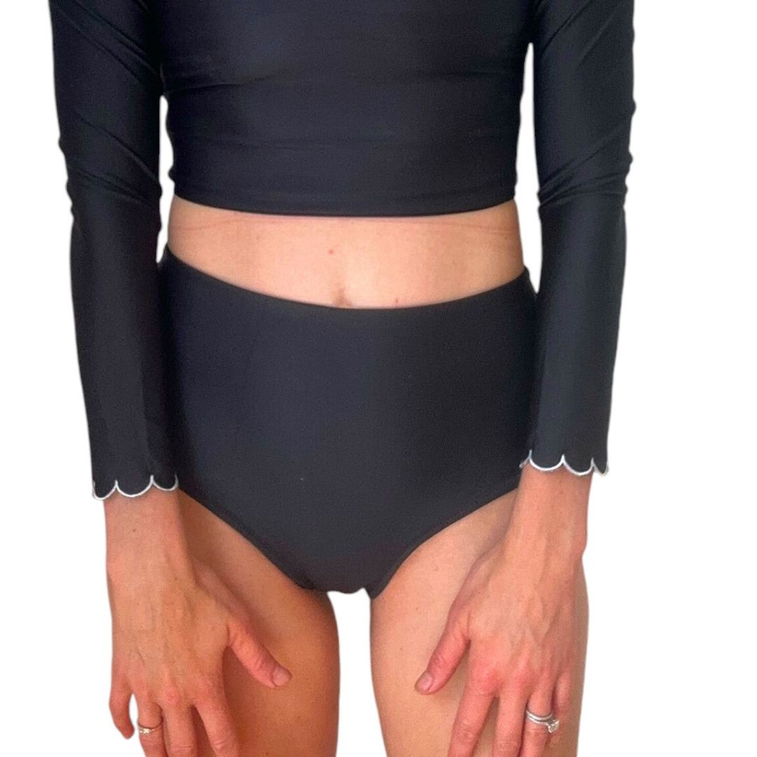 High Waist Black Swim Bottoms on model showing scalloped sleeve trim and high waisted fit with crop top