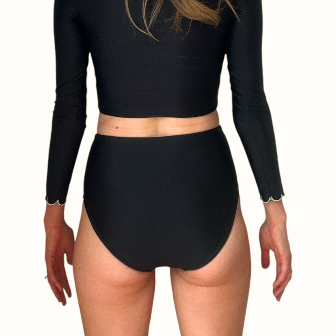 Back view of High Waist Black Swim Bottoms showing full coverage design and high waisted fit on model