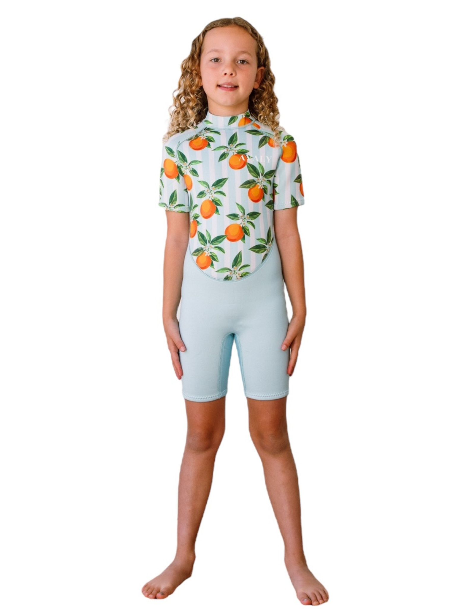 Girl modeling Blue Mandarins NOOSA wetsuit with orange citrus print on torso and light blue shorts sleeves