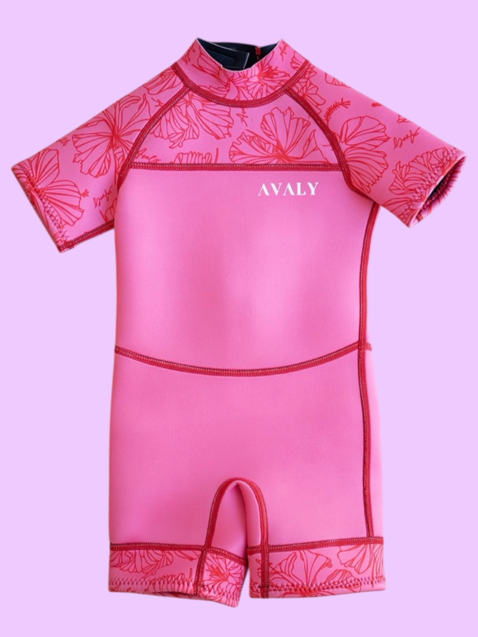 Flat lay of Pink Hibiscus Kids Wetsuit showing bright pink body with coral hibiscus print sleeves and leg cuffs