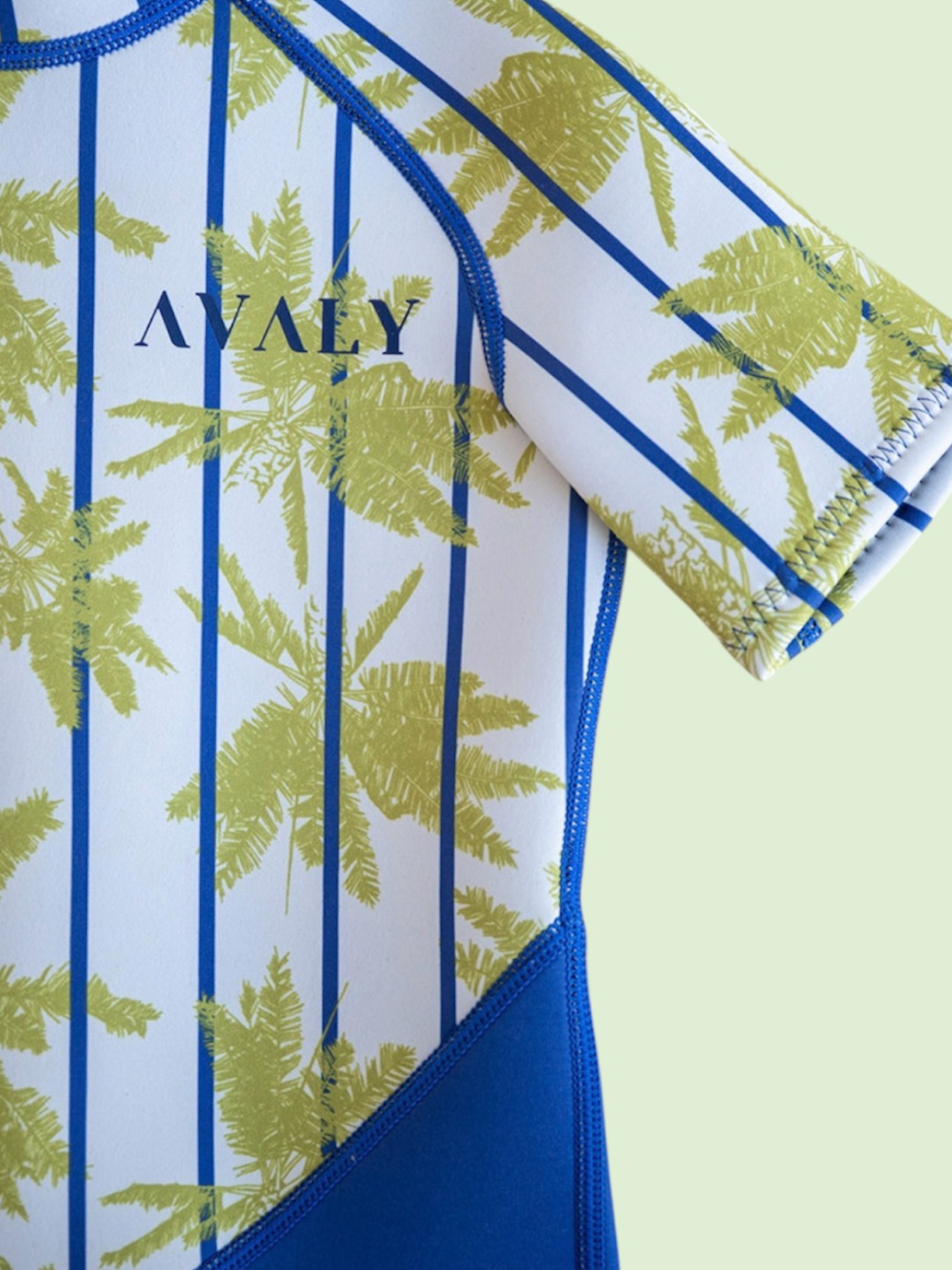 Close up detail of Blue Palm Kids Wetsuit showing tropical palm tree print with blue stripes and blue trim stitching