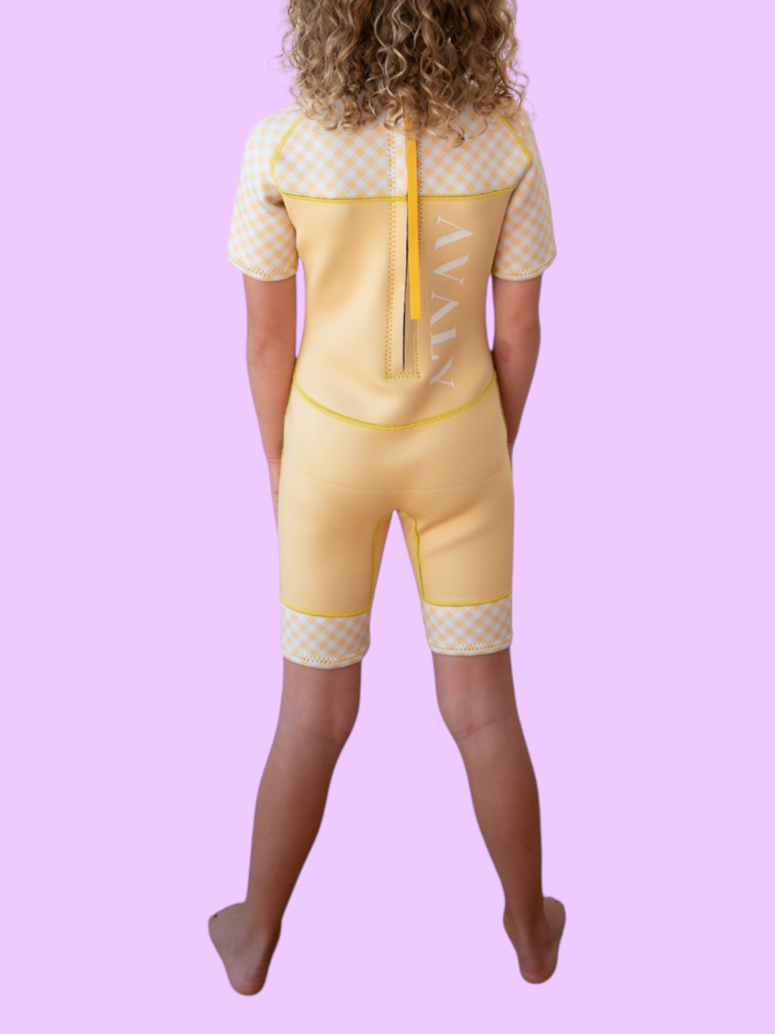 Back view of child wearing Yellow Gingham Kids Wetsuit showing checkered pattern details and back zip closure