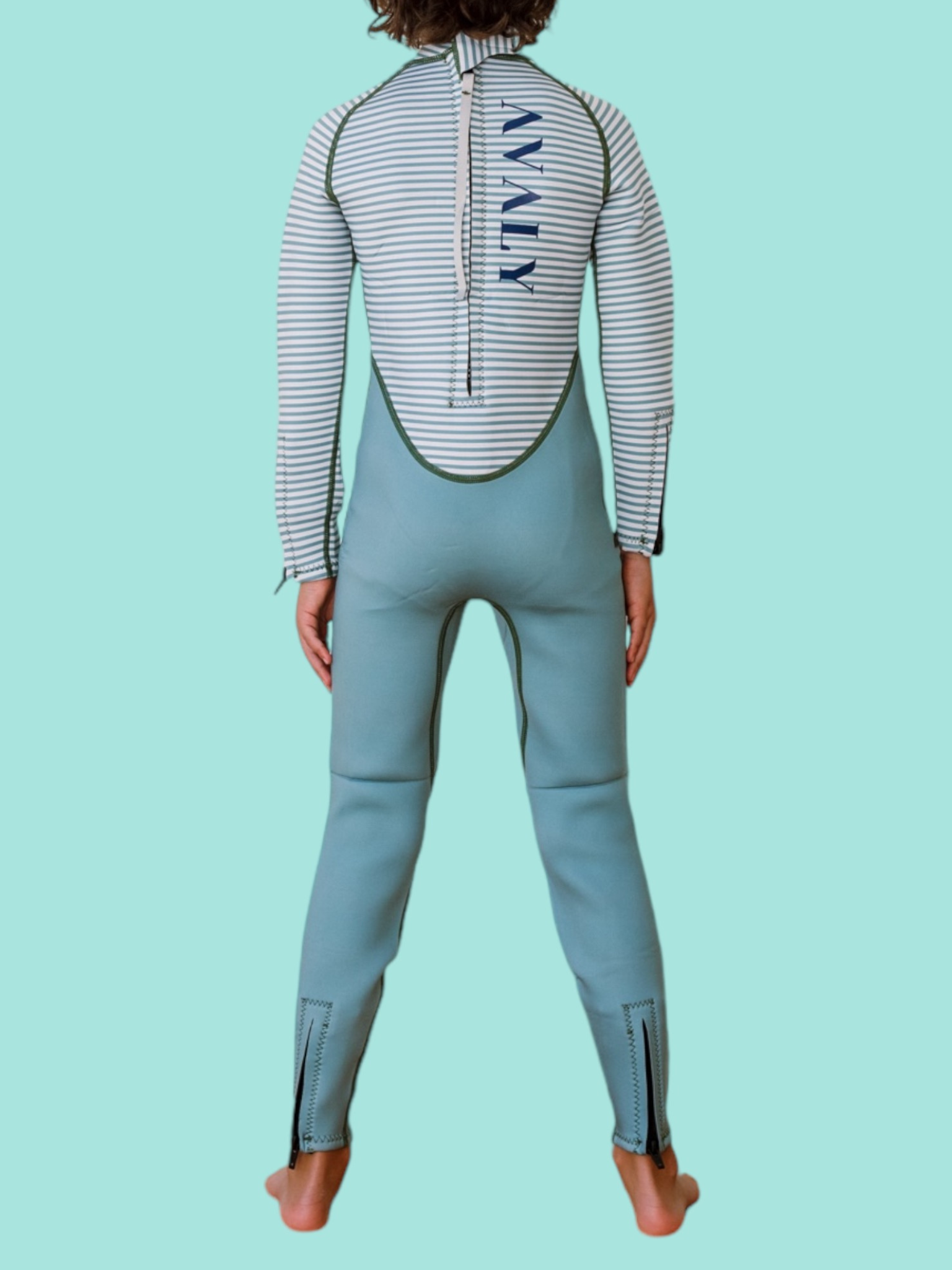 Back view of child wearing Green Striped Kids Sustainable Wetsuit showing blue striped top and sage green bottom