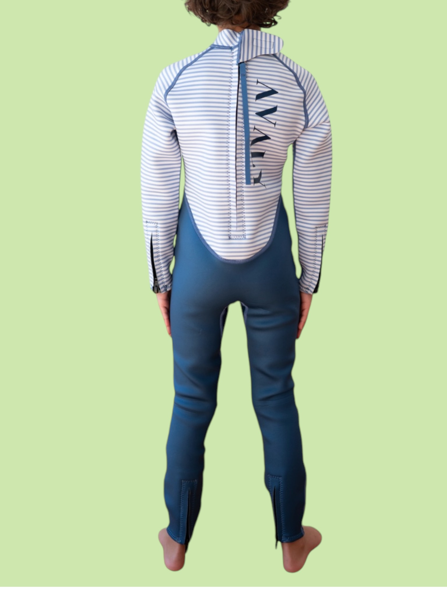 Back view of child wearing Navy & White Striped Kids Sustainable Wetsuit showing blue pants and striped long sleeve top