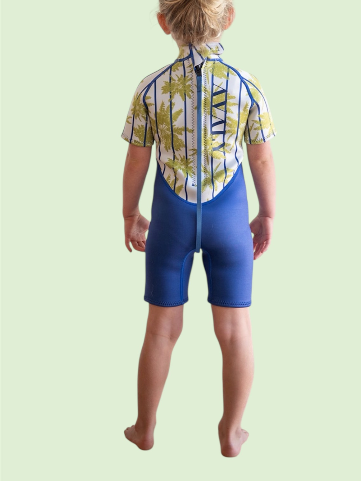 Back view of child wearing Blue Palm Kids Wetsuit in blue with tropical palm print short sleeves and blue neoprene shorts