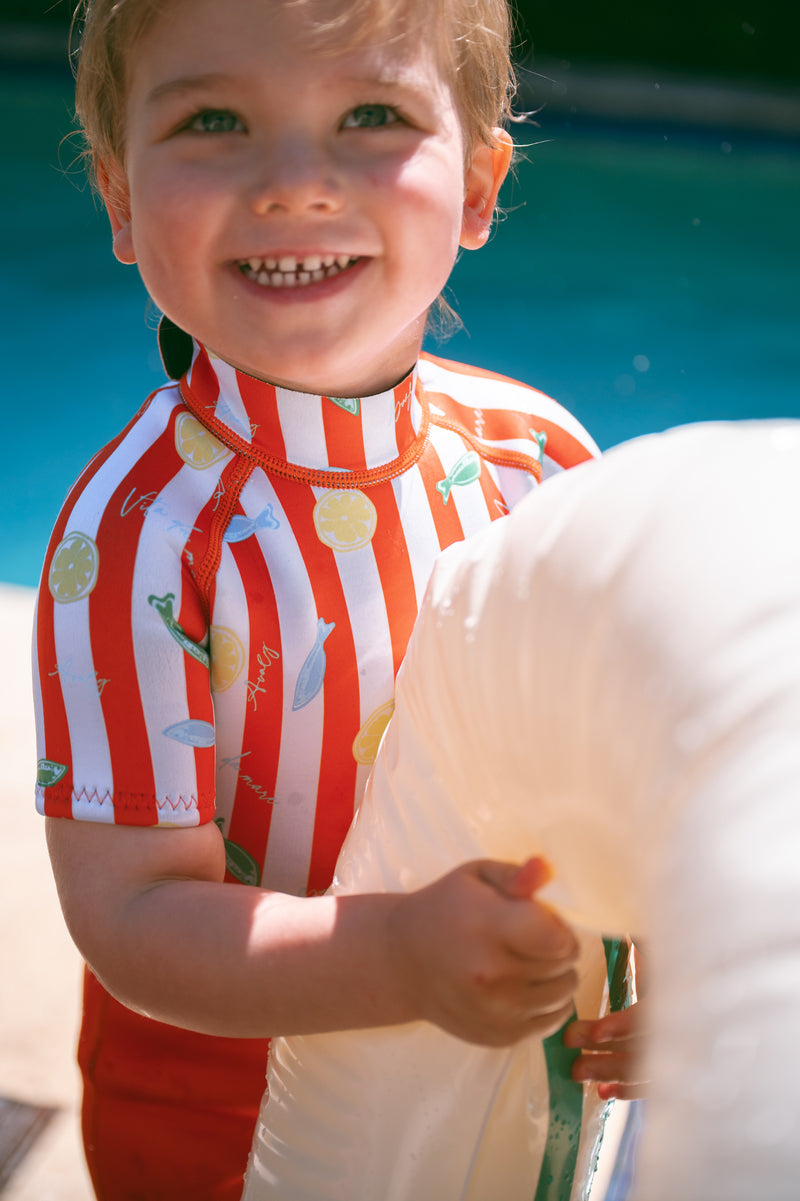 Toddler in AVALY springsuit close-up by the pool
