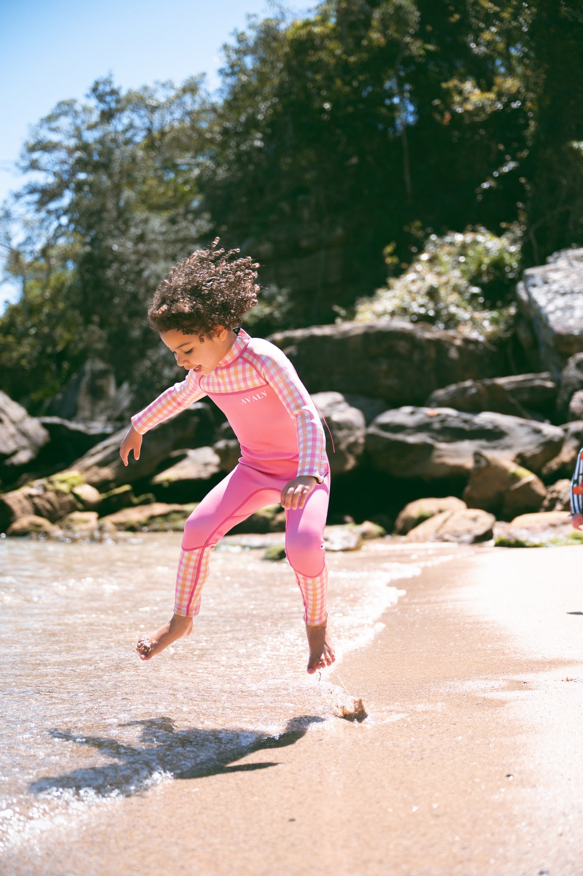 Child jumping joyfully on an Australian beach