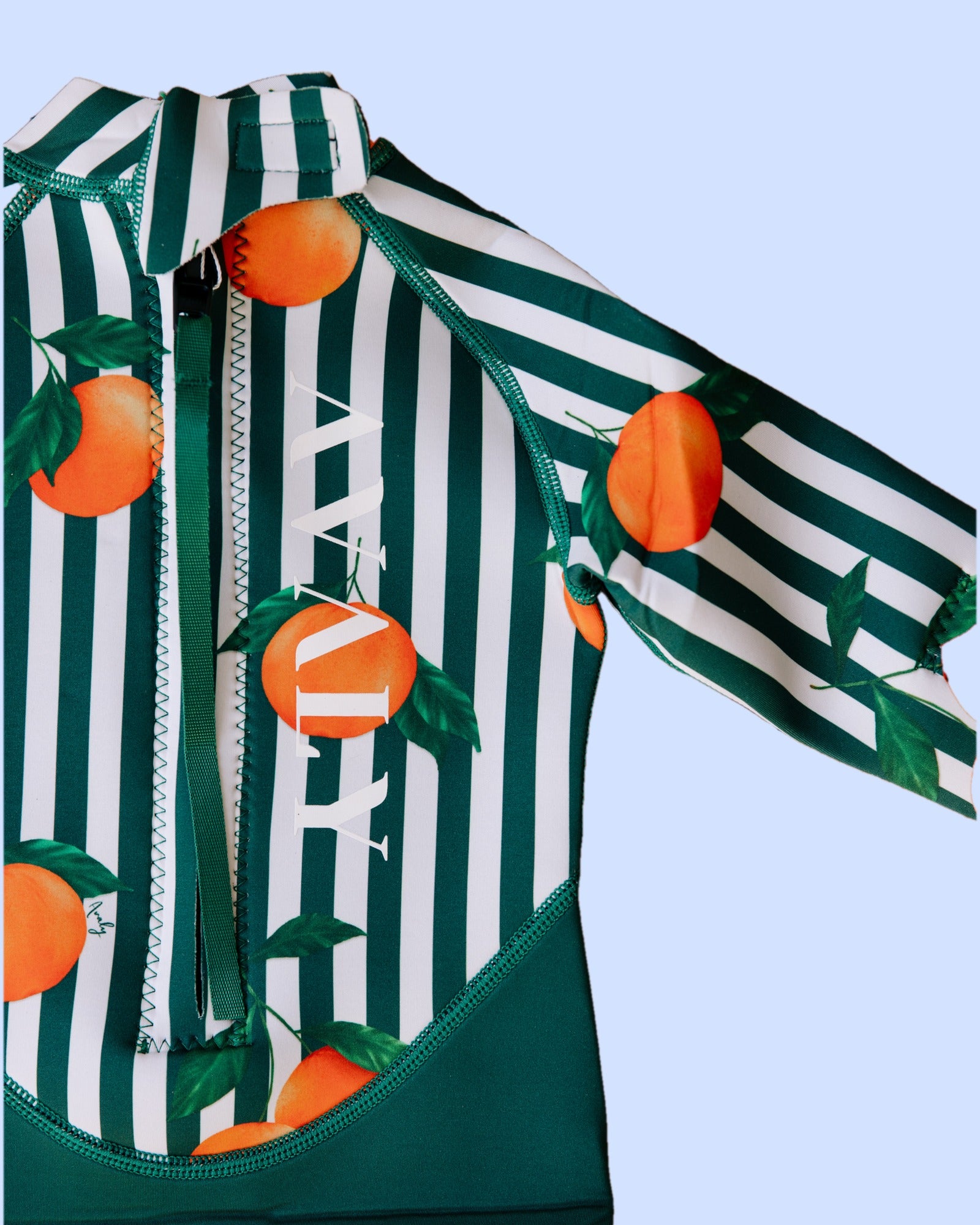Close up of the AVALY Forest Green & Mandarins back zip and AVALY logo