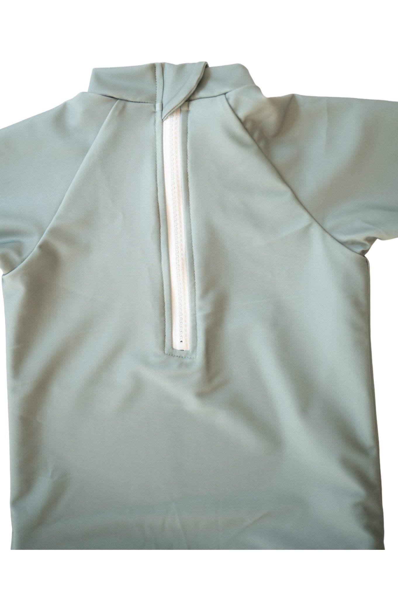 Flat lay of Sage Manly Sustainable Rash Top showing mint green fabric with white zip placket and drawstring hood