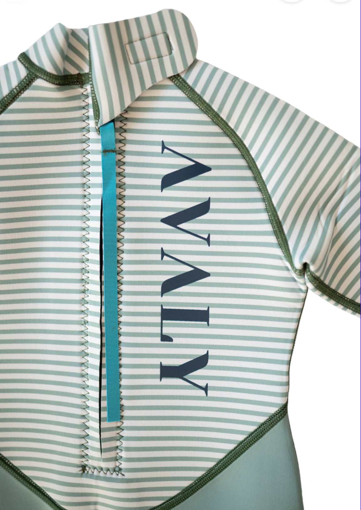 Close up detail of Green Striped Kids Sustainable Wetsuit showing AVALY logo on striped pattern with turquoise zipper