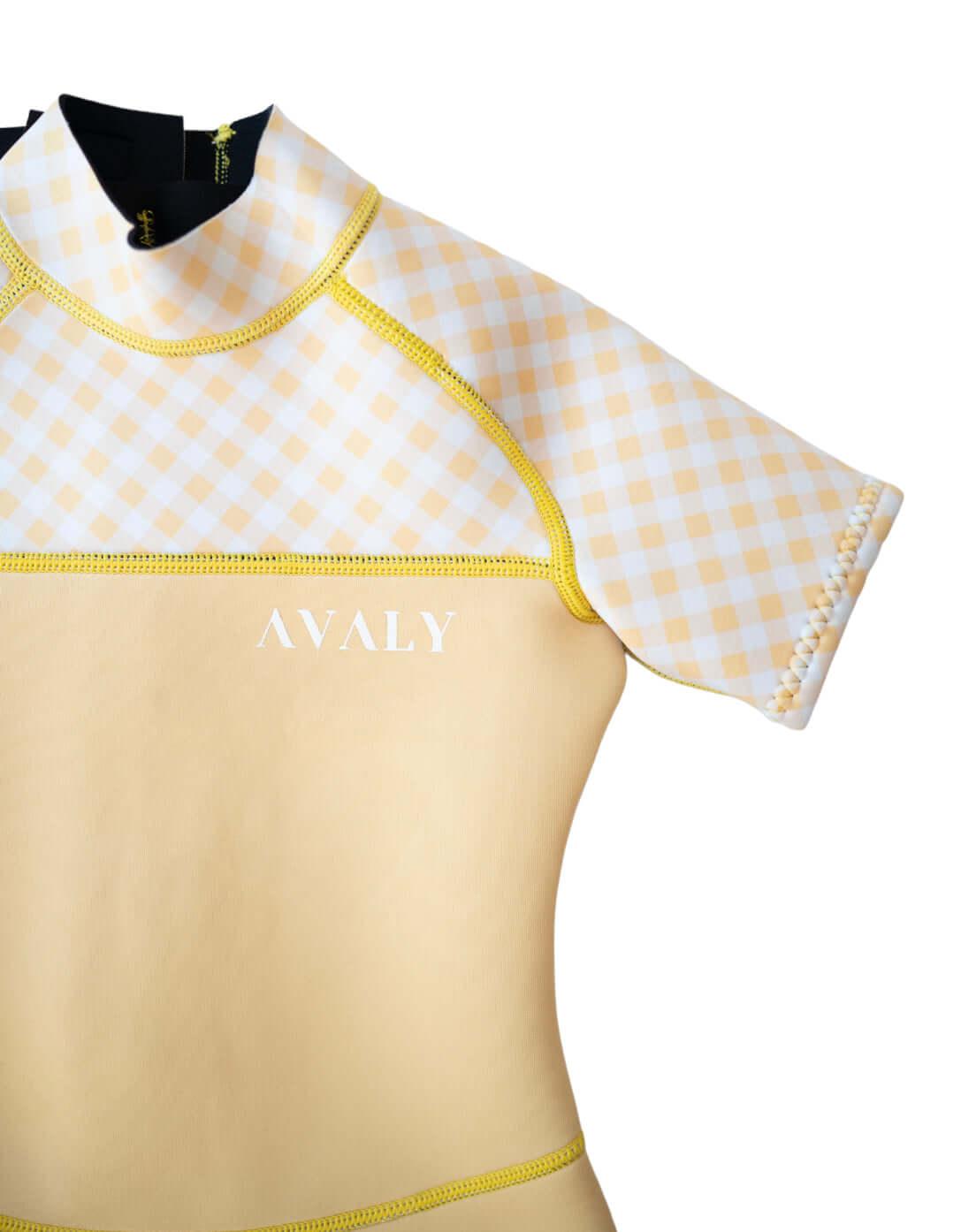 Detail shot of Yellow Gingham Kids Wetsuit showing checkered pattern sleeve with yellow contrast stitching and AVALY branding