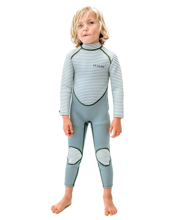 Child wearing Green Striped Austinmer wetsuit with sage green base and white striped rashie top